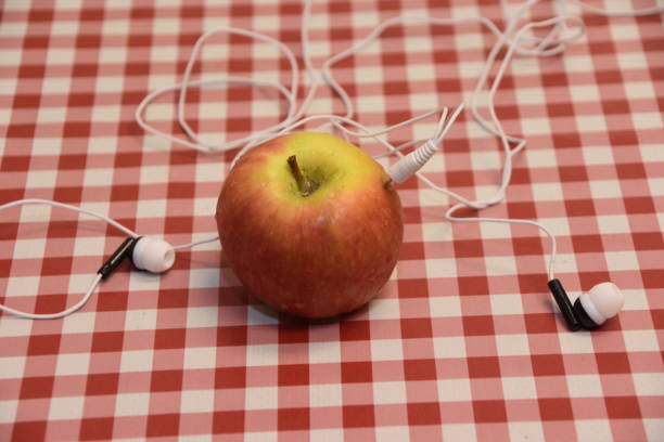 Headphones and apple Headphones and apple apple with bite out of it stock pictures, royalty-free photos & images