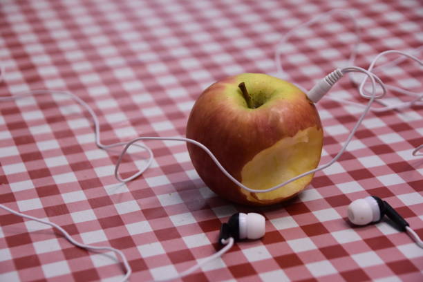 Headphones and apple Headphones and apple apple with bite out of it stock pictures, royalty-free photos & images