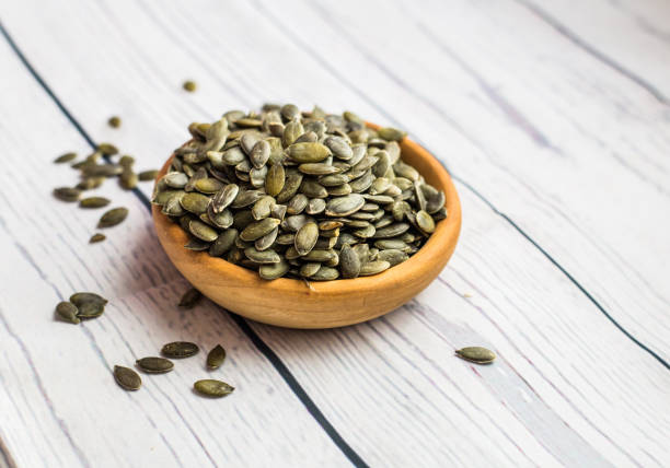 istock Raw pumpkin seeds, food background, top view 901097208
