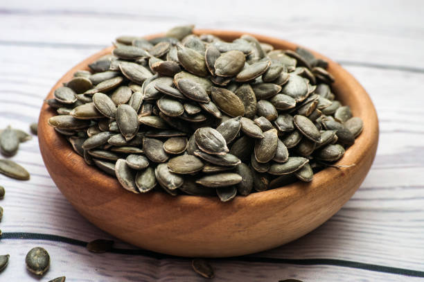 istock Raw pumpkin seeds, food background, top view 901097244