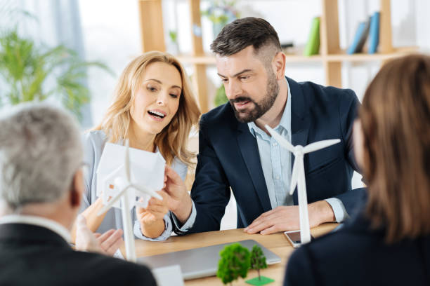 istock Emotional engineer holding a miniature house while explaining its peculiarities 901098290
