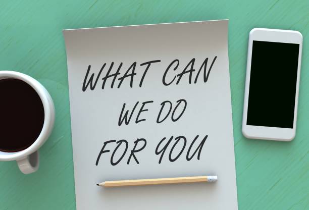 WHAT CAN WE DO FOR YOU, message on paper, smart phone and coffee on table