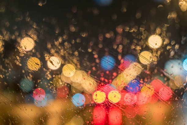 istock defocused road with lights through wet car window 901105598