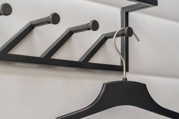 istock black plastic hangers on white wall background 901105624