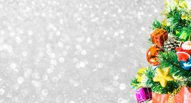 istock Tree and Christmas decorations. Beautiful decorated with present boxes in a winter landscape with snow. 901105698