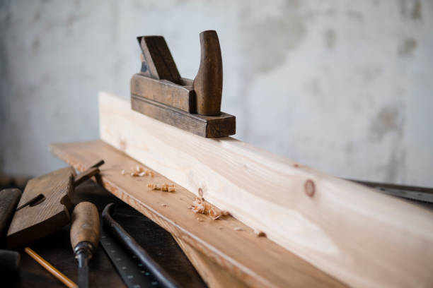 istock Wood planer and shavings at carpenters workshop. Joiner's tools. 901108536