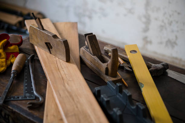 istock Wood planer and shavings at carpenters workshop. Joiner's tools. 901109126