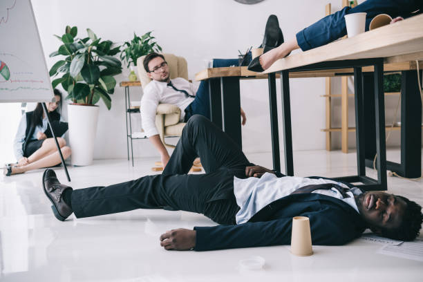 istock exhausted businesspeople sleeping in conference hall at office 901109226