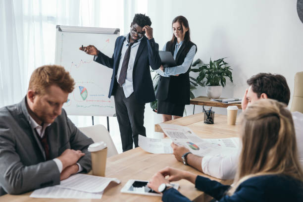istock exhausted zombie like businesspeople having conversation at office 901110068
