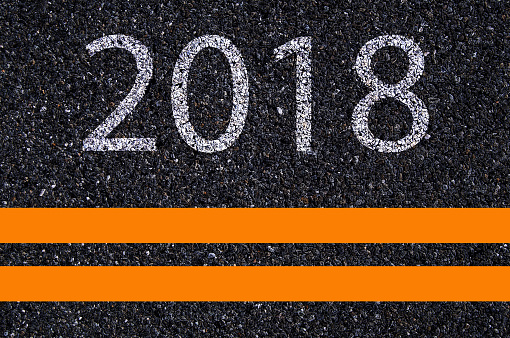 Happy new year 2018 painted on highway road background.
