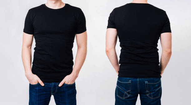 hombre en camiseta negra en blanco sobre fondo gris - black backgound fotografías e imágenes de stock