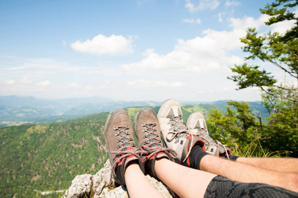 istock Mountain view over women legs as she rests on mountain peak 901110522
