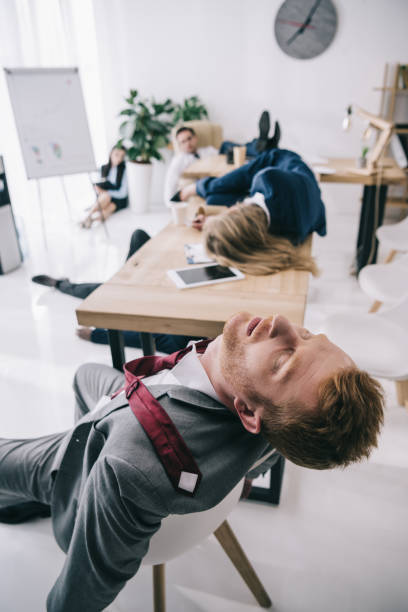 istock overworked business colleagues sleeping at office 901117054