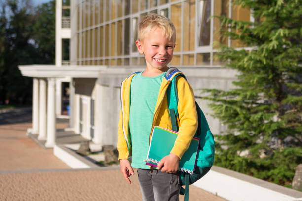 istock Cute schoolboy with books and a backpack 901120964