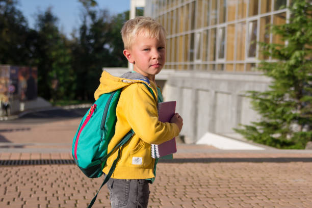 istock Cute schoolboy with books and a backpack 901121522