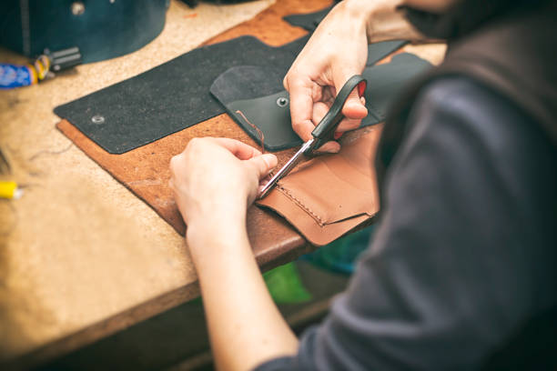 The young woman works with leather stock photo