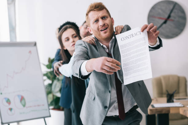 istock zombie like standing in row and holding contract at office 901125216