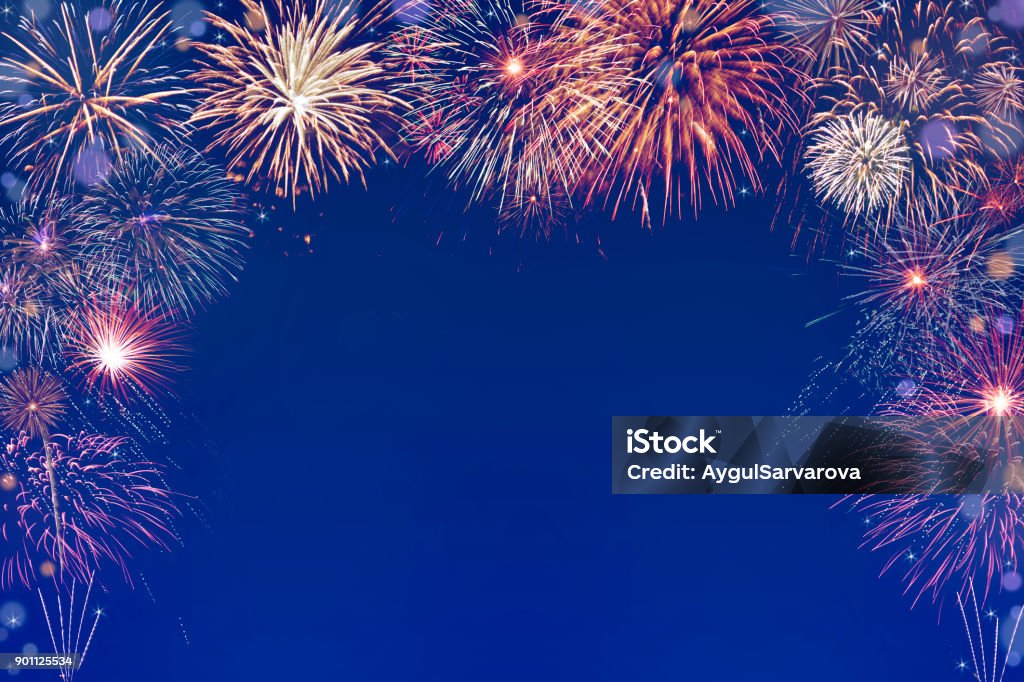 colourful fireworks background with space in the middle new year fireworks on dark purple blue background with copy space in the middle Firework - Explosive Material Stock Photo