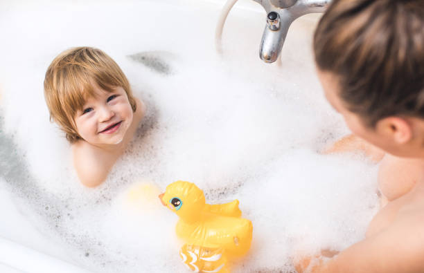 istock Baby Boy Playing in Bathtub With Parent 901125540