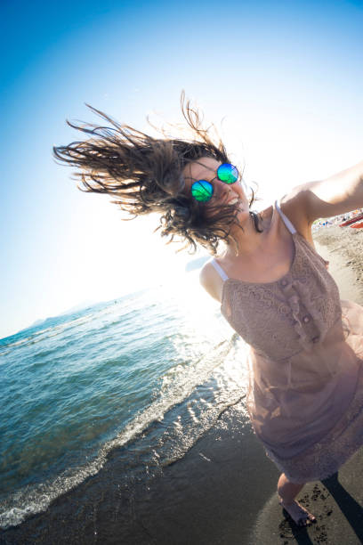 Young woman having fun next to the seacoast