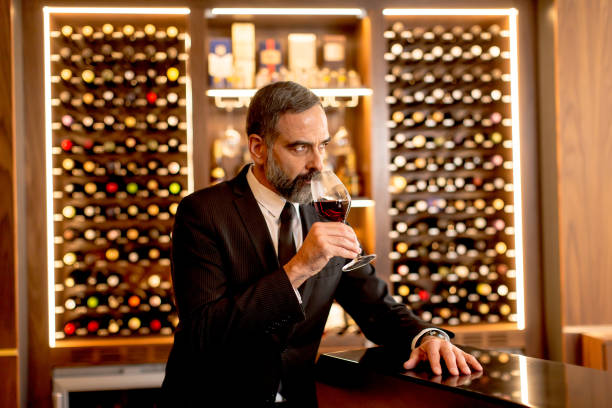 istock Handsome mature man tasting red wine 901130806