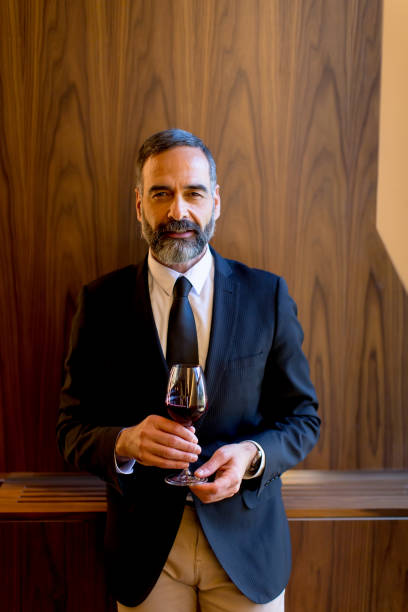 istock Handsome man with glass of red wine 901130808