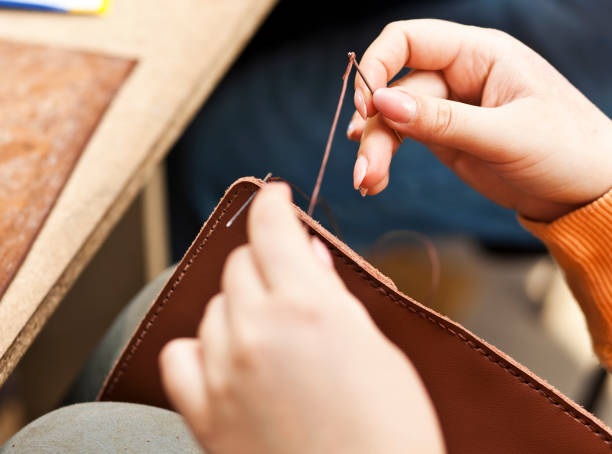 istock The young woman works with leather 901131640