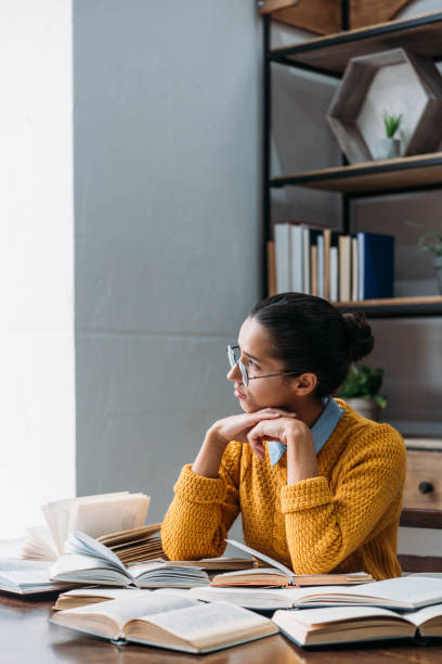 istock girl preparing for exam at library and looking at window 901133554
