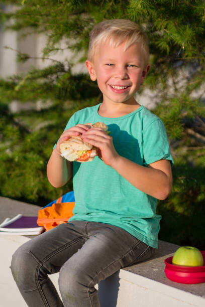 istock Cute schoolboy with books and a backpack 901134518