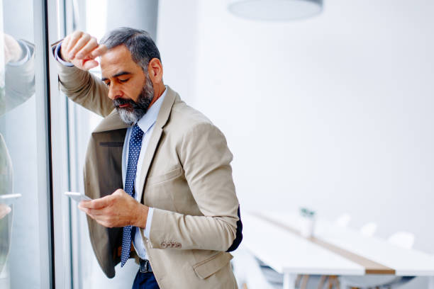 istock Handsome mature businessman  with mobile phone 901135082