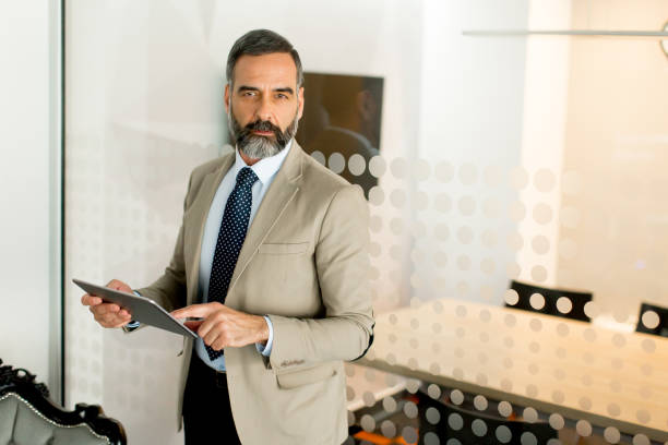 istock Handsome mature businessman with digital tablet 901136640