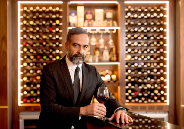 istock Handsome mature man tasting red wine 901138212