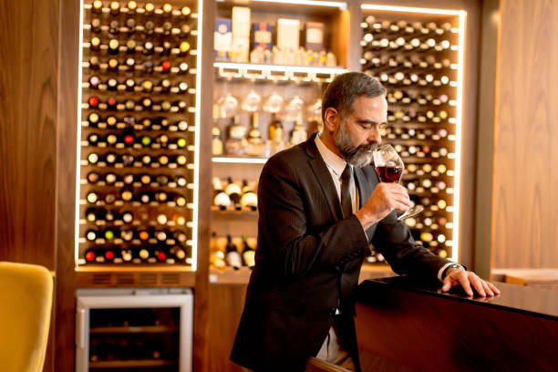 istock Handsome mature man tasting red wine 901138224