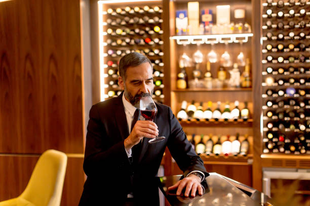 istock Handsome mature man tasting red wine 901138226