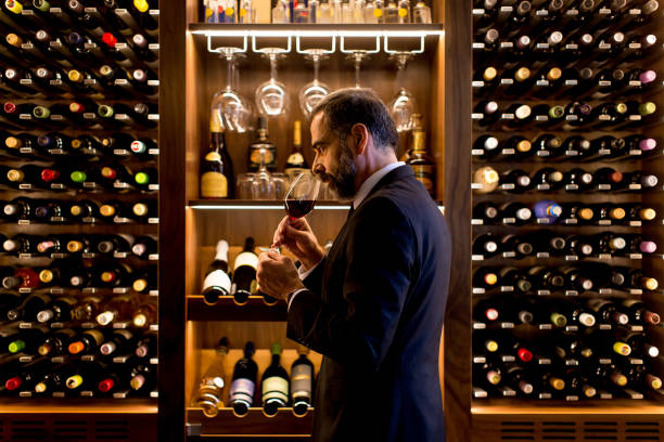 istock Handsome mature man tasting red wine 901138228