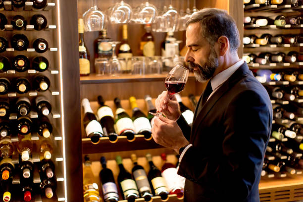 istock Handsome mature man tasting red wine 901138230