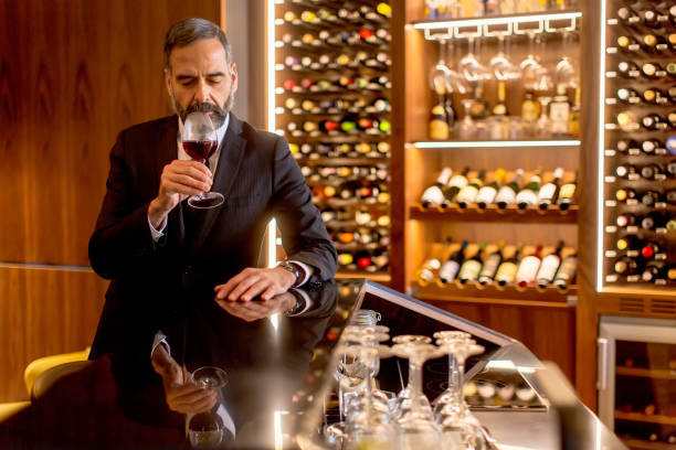 istock Handsome mature man tasting red wine 901138234