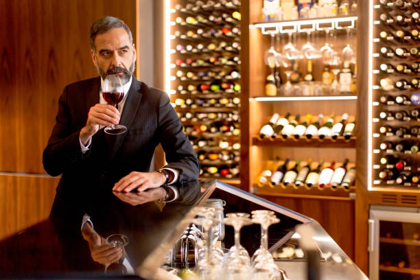 istock Handsome mature man tasting red wine 901138236