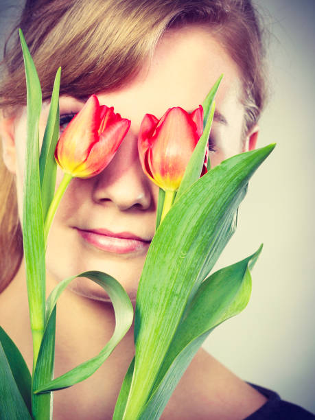 istock Blonde girl blinded by flowers. 901140362