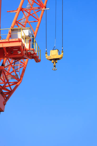 istock Cranes at port area and blue sky 901140534