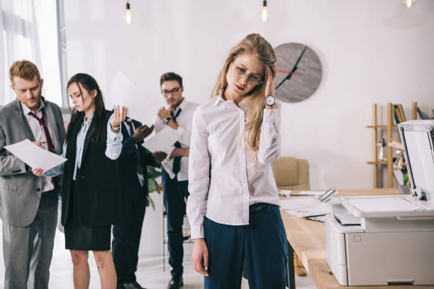 istock young manageress with headache waiting near copier at office 901141484