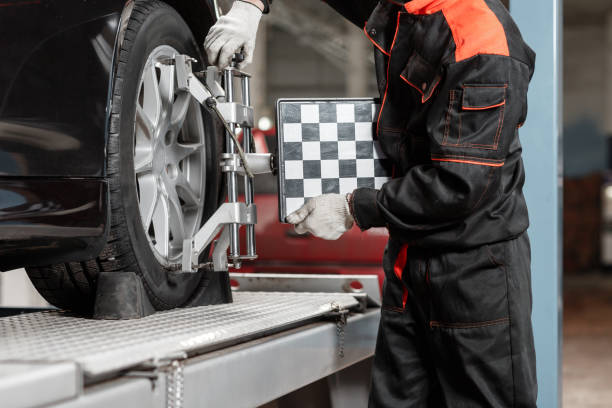auto mechanic sets the car for diagnostics and configuration. Wheel alignment equipment on a car wheel in a repair station auto mechanic sets the car for diagnostics and configuration. Wheel alignment equipment on a car wheel in a repair station. tick animal photos stock pictures, royalty-free photos & images