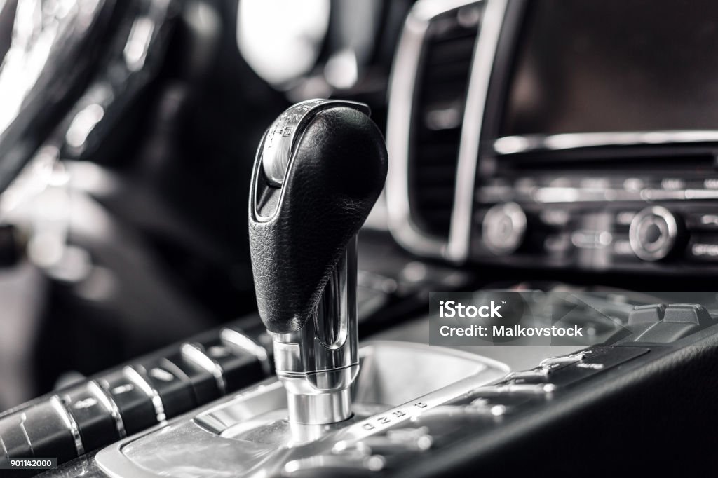 Close-up on automatic transmission lever in modern car. multimedia and navigation control buttons. Car interior details. Transmission shift. Close-up on automatic transmission lever in modern car. multimedia and navigation control buttons. Car interior details. Transmission shift Automatic Gearshift Stock Photo