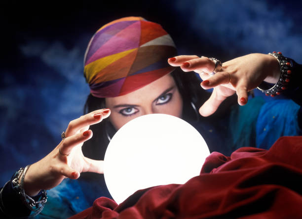istock Mysterious fortune teller with  glowing crystal ball 901142338