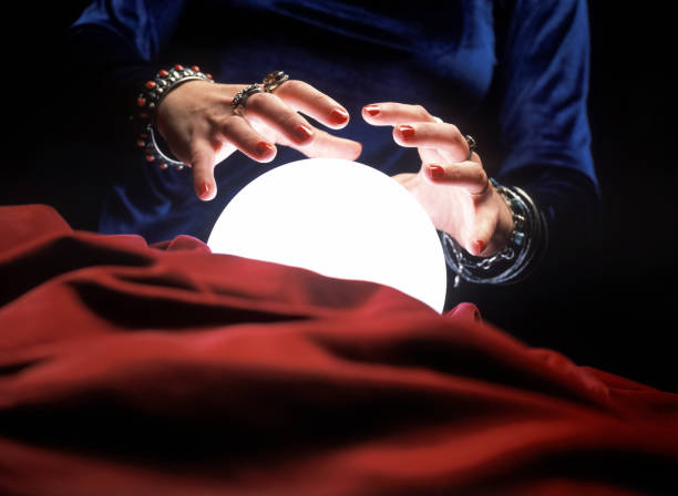 istock Fortune teller hands on glowing crystal ball 901144634