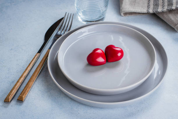 istock Valentine's day background table setting with two ceramic hearts on plate. Top view, copy space 901149554