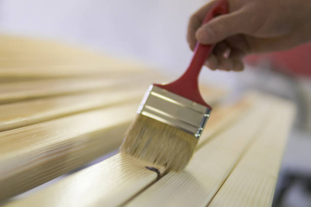 istock Young man painting an old wooden table 901157046