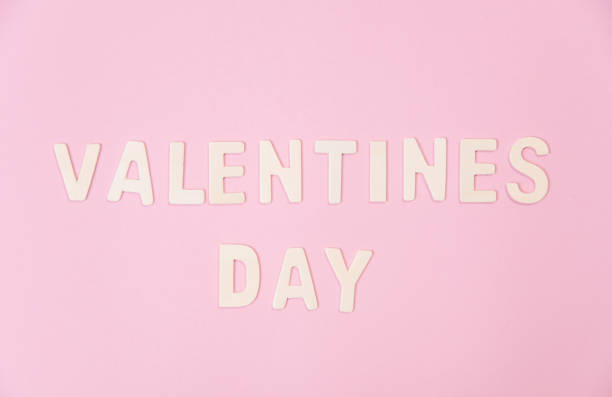 istock wood valentines day word on pink background. 901159964