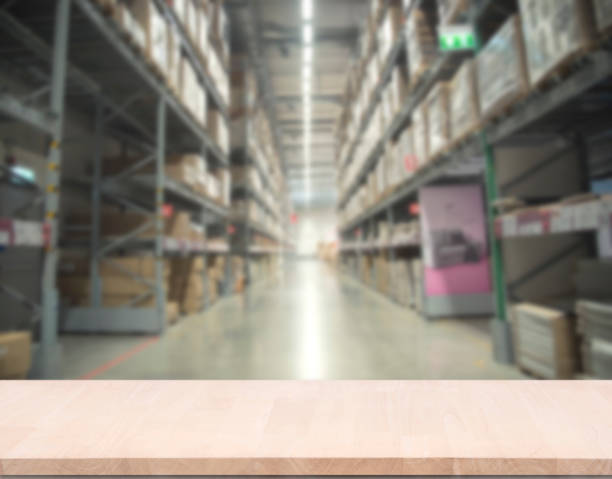 istock top empty wood table on blurred abstract store background. can be used for display or montage your product. 901159966