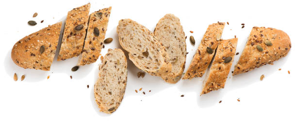 Grain bread with seeds.Above view. Top view of bread with different seeds ( pumpkin,  poppy, flax, sunflower, sesame,  millet ) decorated with wheat ears isolated on white background. slice of bread stock pictures, royalty-free photos & images